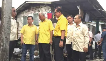  ??  ?? (From left) Zaidi, Dr Sim, Ting, Lee and others make a site inspection at the Kampung Pasir (Lutong) squatter colony.