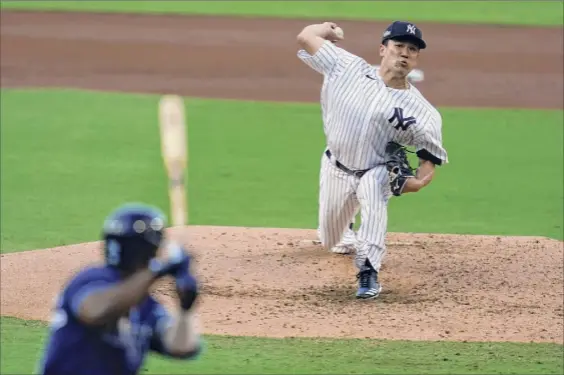  ?? Gregory Bull / Associated Press ?? Yankees starting pitcher Masahiro Tanaka throws a pitch against Tampa Bay. He gave up five runs and eight hits in four-plus innings Wednesday.