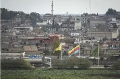  ??  ?? Nusaybin district in Mardin, Turkey, where flags of the Kurdish YPG fly over the border in Qamishli, Syria (Getty)