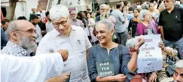  ?? ?? Booker Prize-winning novelist Arundhati Roy, pictured in grey, was among those who attended a protest on Wednesday