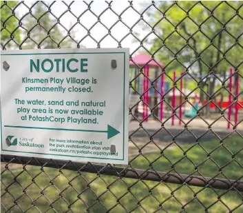  ?? KAYLE NEIS ?? A city of Saskatoon sign warns park goers that the old Kinsmen play village is closed. The equipment is supposed to be moved to Ashworth Holmes Park in Caswell Hill but a petition opposes the move.