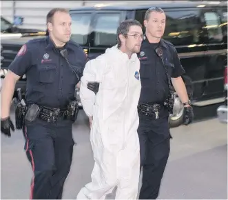  ?? BRYAN PASSIFIUME ?? Calgary police escort Daniel Loveys, 28, into the arrest processing unit last Thursday.