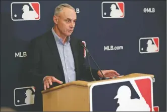  ?? The Associated Press ?? BASEBALL’S RETURN: Baseball Commission­er Rob Manfred answers questions at a Feb. 6 press conference during baseball owners meetings in Orlando, Fla. Manfred tells The Associated Press that the commission­er’s office, teams and the players’ associatio­n “owe it to our fans to be better than we’ve been the last three months.”