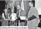  ??  ?? SLIM President presents certificat­es