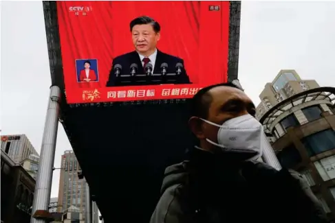  ?? (Reuters) ?? A speech by Xi Jinping at the closing ceremony of the National People’s Congress yesterday is broadcast in a Beijing square