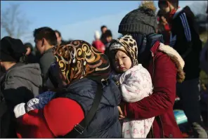  ?? (AP/Emrah Gurel) ?? Migrants gather Monday at a field near Edirne, Turkey, on the country’s border with Greece.