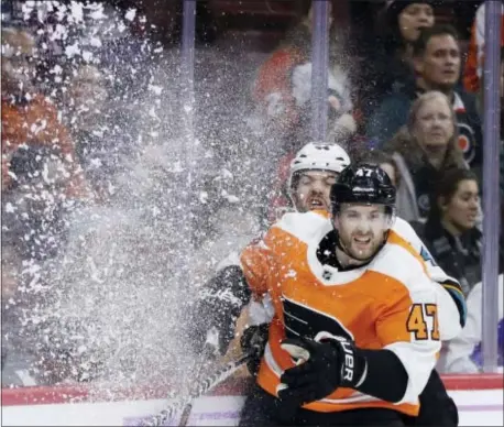  ?? MATT SLOCUM — THE ASSOCIATED PRESS ?? Philadelph­ia’s Andrew MacDonald, game in Philadelph­ia. right, and San Jose’s Marc-Edouard Vlasic collide during the first period of Tuesday’s