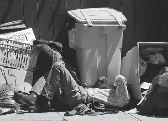  ?? JEFF CHIU / AP ?? A homeless man sleeps on the street in San Francisco, California, in August.