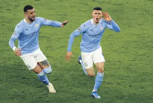  ??  ?? Manchester City’s Phil Foden (R) celebrates with teammate Kyle Walker after scoring against Borussia Dortmund in the UEFA Champions League quarterfin­al, second leg match in Dortmund, Germany, April 14, 2021.