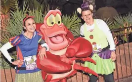  ?? PROVIDED BY RUNDISNEY ?? Participan­ts take a photo with Sebastian during the 25th annual Walt Disney World Marathon Weekend in 2018.