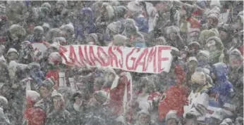  ?? MARK BLINCH/THE CANADIAN PRESS ?? Signs of hockey were everywhere at Friday’s world junior outdoor game at New Era Field. Snow was an issue throughout the contest between Canada and the U.S., creating bad bounces and keeping the ice crew hopping.