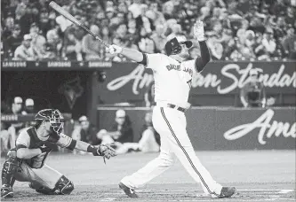  ?? NATHAN DENETTE THE CANADIAN PRESS ?? Blue Jays first baseman Rowdy Tellez hits a two-run home run as Tampa Bay Rays catcher Nick Ciuffo looks on during second-inning American League baseball action in Toronto on Thursday night.