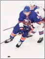  ?? Mary Altaffer / Associated Press ?? Islanders defenseman Ryan Pulock skates against Rangers right wing Kaapo Kakko during the second period of a preseason game on Saturday in Bridgeport.