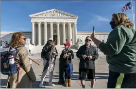  ?? J. SCOTT APPLEWHITE — THE ASSOCIATED PRESS ?? Protesters for and against President Donald Trump debate each other at the Supreme Court in Washington on Friday.