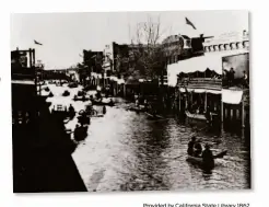  ?? Provided by California State Library 1862 ?? Water fills K Street in Sacramento during the Great Flood of 1862, the result of several rainstorms over a 43-day span. Climate change makes such disasters more likely, scientists say.