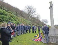  ?? 25_c46wargrav­es02 ?? As the last post ended the standards were lowered during Saturday’s service.