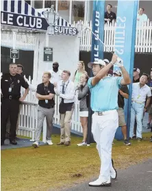  ?? AP PHOtOS ?? IFFY CONDITIONS: On a day where weather wreaked havoc with play, Hideki Matsuyama fired a 64 that included a shot from near a walkway on No. 16.