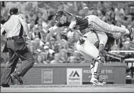  ?? AP FILE PHOTO ?? ABOVE: The Blue Jays’ Chris Coghlan (top) leaps over Cardinals catcher Yadier Molina to score during the seventh inning April 25 in St. Louis. Coghlan went airborne, flipped over Molina and somehow landed on the plate, giving the Blue Jays a 3-2...