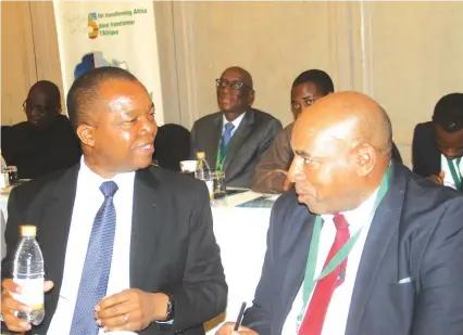  ?? — Picture by Tariro Kamangira ?? Reserve Bank of Zimbabwe Governor Dr John Mangudya (left) chats with Accountant General Daniel Muchemwa at a Private Sector Developmen­t Round-Table event in Harare yesterday.