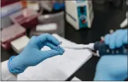  ?? ANTHONY KWAN — BLOOMBERG FILE ?? A laboratory technician pipettes test sample in Hong Kong, China, on Tuesday, June 20, 2017.