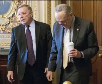  ?? J. SCOTT APPLEWHITE — THE ASSOCIATED PRESS ?? Sen. Dick Durbin, D-Ill., left, and Senate Minority Leader Chuck Schumer, D-N.Y., walk together outside the chamber during debate in the Senate on immigratio­n, at the Capitol in Washington, Wednesday. Schumer said on the Senate floor that “the one...