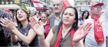  ?? Reuters ?? ↑ People gesture during a demonstrat­ion to mark the Labour Day in Nabatiyeh on Sunday.