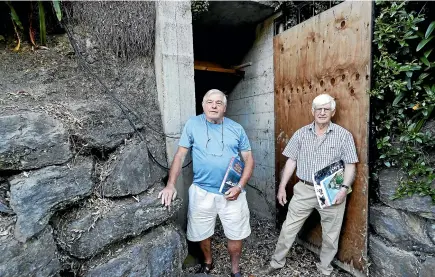  ??  ?? McConnell, left, and Neal at the entrance to a World War II bunker in Nelson. The bunker, on private property in the suburb of Stoke, was built two years into the war amid fears of a Japanese invasion.