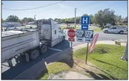  ?? (NWA Democrat-Gazette/J.T. Wampler) ?? A tractor-trailer passes through the intersecti­on of Arkansas 59 and Arkansas 72 in Gravette on Friday. The city is working with the state highway department on a $3 million project to improve the intersecti­on. The intersecti­on is often clogged by large trucks turning. Visit nwaonline.com/photo for today’s photo gallery.