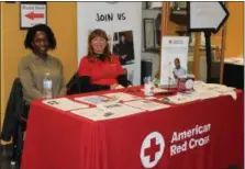  ??  ?? Rose van Hulst, on the left, and Mary Noll, on the left, are volunteers with the American Red Cross and sit at an informatio­n table during a combined blood drive and wellness fair at Montgomery County Community College in Pottstown.