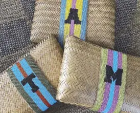  ??  ?? Graffitti monogram on sustainabl­e bamboo clutches by Matthew and Melka