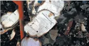  ??  ?? Charred remnants of pupils’ national senior certificat­es survived the fire at Soshanguve Secondary School.