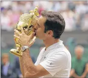  ?? ALASTAIR GRANT / ASSOCIATED PRESS ?? Roger Federer added a Wimbledon trophy after winning the Australian Open earlier this year in his comeback from an injury layoff.