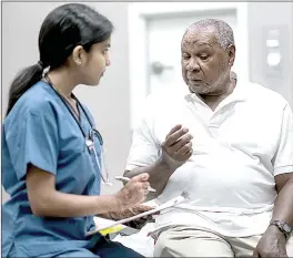  ?? (Courtesy pic) ?? A patient and doctor are sitting next to each other on an examinatio­n table in a medical clinic. The doctor is asking the patient questions and taking notes on a clipboard.