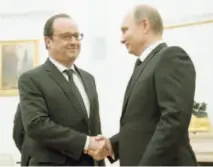  ??  ?? Hollande estrecha la mano de Putin tras llegar a entendidos sobre acciones contra el Estado Islámico.