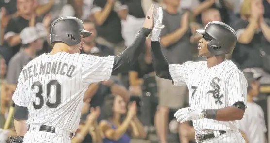  ??  ?? White Sox shortstop Tim Anderson celebrates with Nicky Delmonico after hitting a two- run home run off Astros starter Collin McHugh in the fifth inning. | CHARLES REX ARBOGAST/ AP