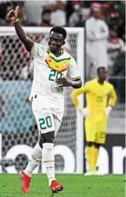  ?? — AFP ?? Right on the mark: Senegal’s bamba dieng (left) celebratin­g after scoring the third goal against Qatar during the Group a match.