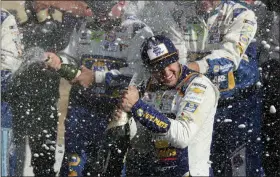  ?? JOHN MUNSON — THE ASSOCIATED PRESS ?? Chase Elliott celebrates his victory with his pit crew after winning at Watkins Glen Internatio­nal, Sunday.