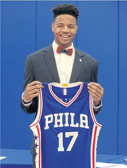  ??  ?? Markelle Fultz poses with his 76ers shirt during a press conference in Philadelph­ia.