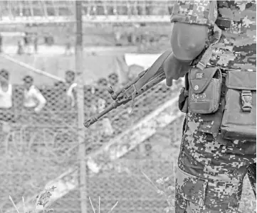  ??  ?? File photo shows Myanmar border guard police patrol the fence in the ‘no man’s land’ zone between Myanmar and Bangladesh border as seen from Maungdaw, Rakhine state during a government-organised visit for journalist­s. — AFP photo