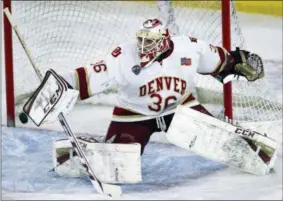  ?? THE ASSOCIATED PRESS ?? In this file photo, Denver goalie Tanner Jaillet makes a blocker save in the first period of an NCAA college hockey game against Wisconsin in Denver. Jaillet will lead Denver ito the NCAA regional playoffs this weekend when the Pioneers play Penn State...