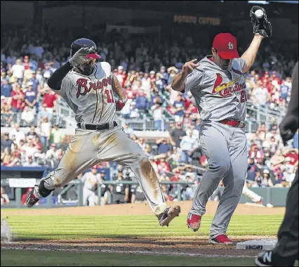  ?? CURTIS COMPTON / CCOMPTON@AJC.COM ?? Cardinals pitcher Seung Hwan Oh wins the foot race to first base on a grounder by the Braves’ Ender Inciarte with the bases loaded and the game tied at 4 during the 11th inning. Had Inciarte been called safe, the Braves would have won the game at...