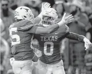  ?? Tim Warner/Getty Images ?? Gunnar Helm, left, celebrates with Ja'Tavion Sanders after a first-half touchdown Saturday in Austin.