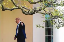  ?? PATRICK SEMANSKY/ASSOCIATED PRESS ?? President Donald Trump gestures to members of the press as he walks to the Oval Office of the White House after visiting the Supreme Court to pay respects to Justice Ruth Bader Ginsburg.