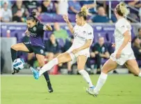  ?? WILLIE J. ALLEN JR./ORLANDO SENTINEL ?? Pride forward Marta controls the ball against two Spirit defenders during a 2022 match at Exploria Stadium.