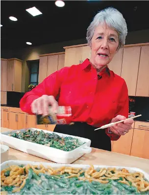  ?? AP Photo/Mel Evans, File ?? Q In this Nov. 15, 2005, file photo, a green bean casserole sits in the foreground as Dorcas Reilly prepares another at the Campbell Soup Co. corporate kitchen in Camden, N.J. Reilly died on Oct. 15 and her family will celebrate her life on Saturday in the town where she lived, Haddonfiel­d, N.J. Reilly was a Campbell Soup kitchen supervisor in 1955 when she combined green beans and cream of mushroom soup, topped with crunchy fried onions, for an Associated Press feature. It is the most popular recipe ever to come out of the corporate kitchen at Campbell Soup.