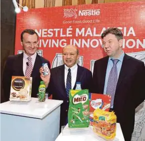  ??  ?? (From left) Nestle (Malaysia) Bhd chief executive officer Alois Hofbauer, chairman Tan Sri Syed Anwar Jamalullai­l, and finance and control executive director Martin Peter Krugel at a recent Nestle product innovation presentati­on.