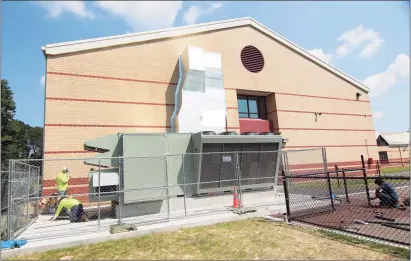  ?? Christian Abraham / Hearst Connecticu­t Media ?? Workers from KMK Insulation of North Haven finish working on the new dedicated outdoor air system at Westover Elementary School in Stamford on Friday.