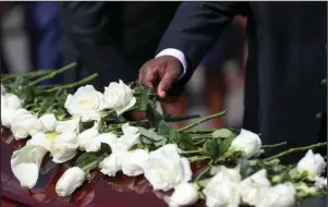  ?? The Associated Press ?? JOHN LEWIS: Family members place flowers on the casket of Rep. John Lewis during the burial service Thursday at South-View Cemetery in Atlanta.