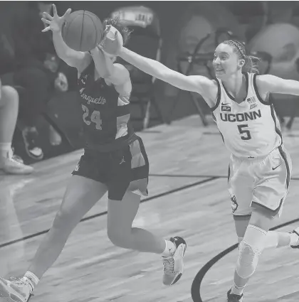  ??  ?? UConn guard Paige Bueckers deflects a pass intended for Marquette guard Selena Lott in the Big East Tournament championsh­ip Monday at Mohegan Sun Arena.