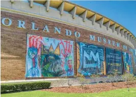  ?? COMPOSITE IMAGE BY RICARDO RAMIREZ BUXEDA/ORLANDO SENTINEL ?? Signs advertise the Jean-Michel Basquiat exhibit outside the Orlando Museum of Art on March 25. The FBI is investigat­ing the authentici­ty of 25 paintings attributed to Basquiat on exhibit there.